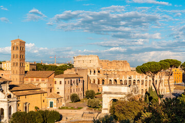Fototapeta na wymiar View of Forum of Rome and Colosseum a sunny summer day in Rome. It was for centuries the center of Roman public life.