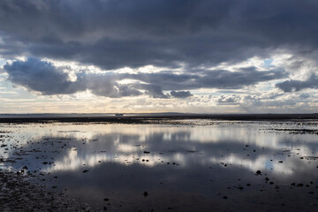 Reflections on Chalkwell beach, near Southend-on-Sea, Essex, England