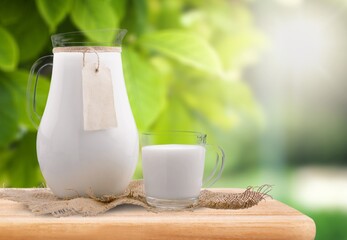 Glass of milk and dairy products on background