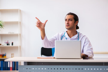 Young male doctor in telemedicine concept