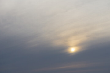 The orange sun setting blue sky with clouds background in twilight