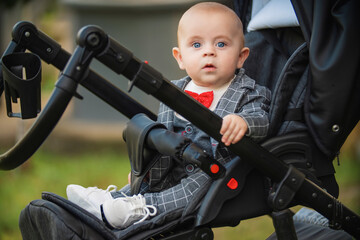 little boy sitting in a stroller