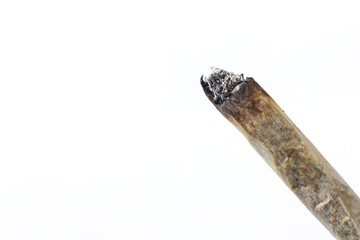 Burning cigarette close up isolated on a white background.  Smoking cannabis joint. Medical use. 	