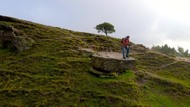 A photographer shooting in Peak District, an upland area in England at the southern end of the Pennines, UK