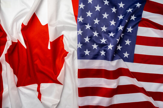 Flags of Canada and USA folded together