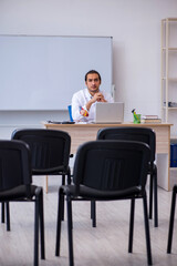 Young male doctor giving seminar in the classroom