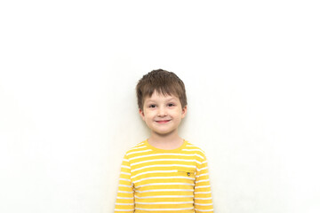 Happy Cute toddler boy caucasian in striped shirt with funny expression.