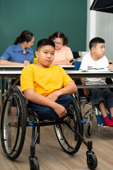 Fototapeta na wymiar disability boy sitting on wheelchair in classroom special with teacher and AUtism kids education