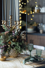 Festive table setting for the new year and christmas. Beautiful decorations, dishes, candles. Quiet family dinner during self-isolation due to covid.