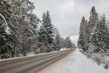 Winter landscape, road, winter track along the forest