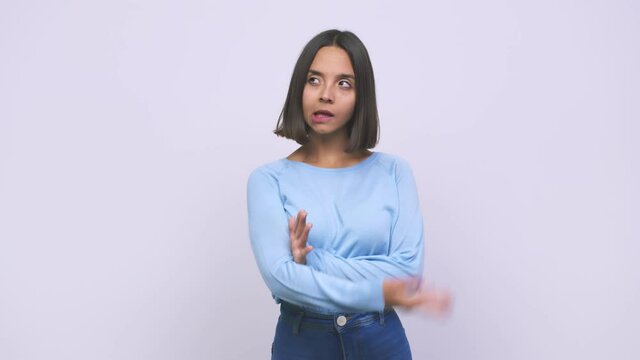 Young mixed race woman confused, feels doubtful and unsure