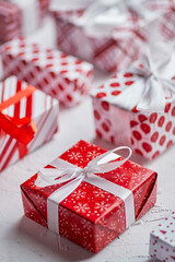 Christmas concept. Close up on festive paper wrapped gifts with ribbon