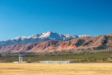Panoramic view of Pikes Peak with air traffic control tower and rock formations. Colorado Springs, Colorado