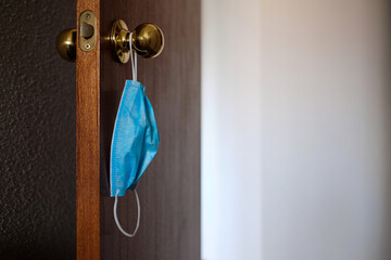 Surgical Mask Hanging On The Doorknob