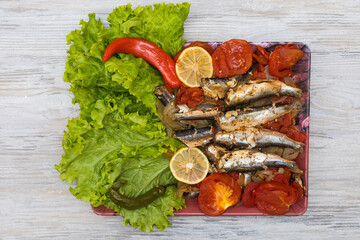 Fish stewed in vegetables with lemon. Culinary background with selective focus