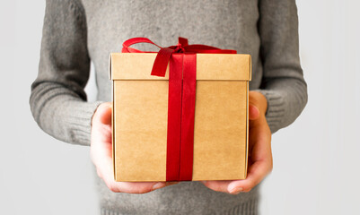 Photo of a man holding a craft red christmas giftbox