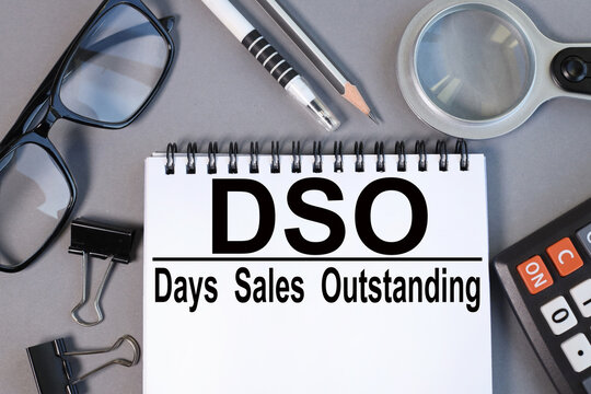 DSO - Days Sales Outstanding, text on notepad on gray background, business concept on blackboard
