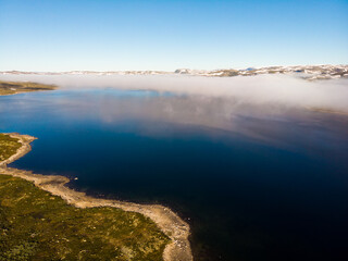 Fototapeta na wymiar Clouds over lake water, Hardangervidda landscape, Norway
