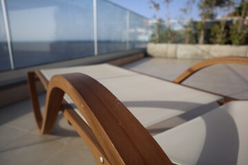 design wooden sun lounger with a view on the atlantic ocean, at Madeira