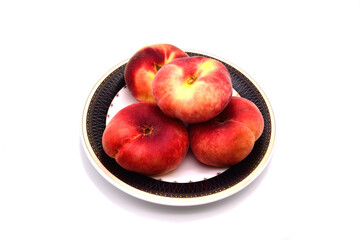Peaches lying on a saucer with a black ornament