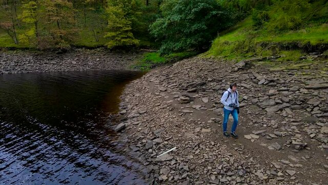 A photographer shooting in Peak District, an upland area in England at the southern end of the Pennines, UK