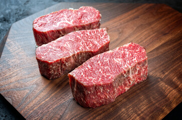 Raw dry aged angus beef fillet steak natural offered as close-up on a modern design plate