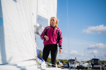 A young girl is photographed on board of a white sports yacht she bought to participate in a...