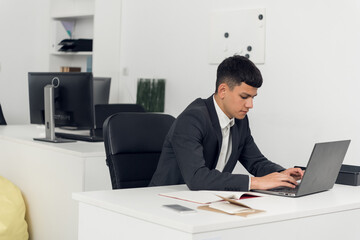 An employee of the LLC works with investment documents on the computer. Closing and opening trades on the basis of the graphs of sales