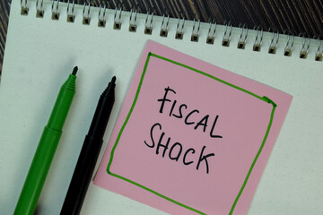 Fiscal Shock write on sticky notes isolated on Wooden Table.