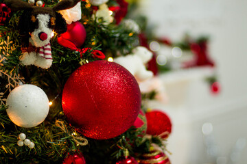 Close up of balls on christmas tree. Bokeh garlands in the background. New Year concept.