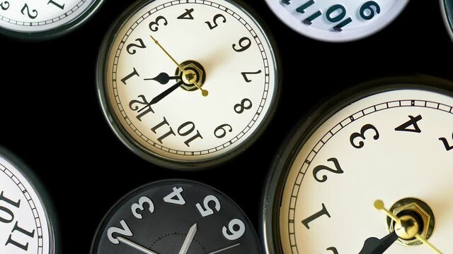 Many time lapse clock faces appear at zoom out all showing different  time. Various clocks in timelapse, busy time flow concept. 4k.