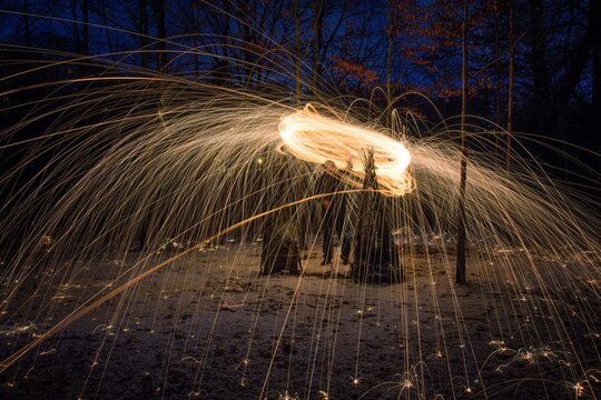 Man Spinning Wire Wool At Night