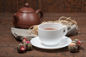 Clay Chinese teapot pot and cup of tea with Flower Chinese tea on old wooden table