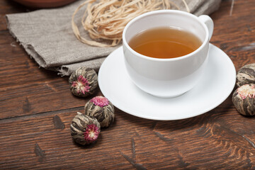 Cup of tea with Flower Chinese tea on old wooden table
