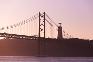 Ponte 25 de Abril Lisboa Lisbon Portugal bridge and Sanctuary of Christ the King, Santuário de Cristo Rei in the morning sunrise over Tagus river
