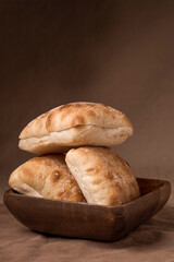 Delicious ciabatta bread stacked in a bowl.