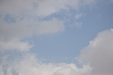 Fototapeta premium Blue sky with puffy white clouds.