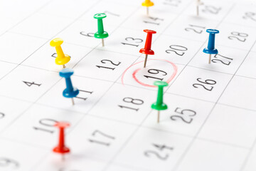 Push pins on calendar. Idea concept of to do planning.