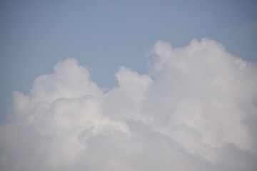 Blue sky with puffy white clouds.