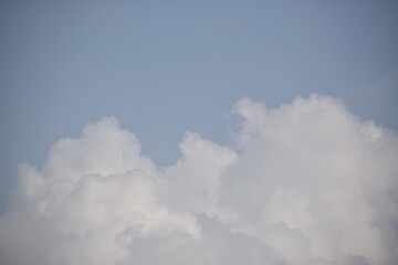 Blue sky with puffy white clouds.