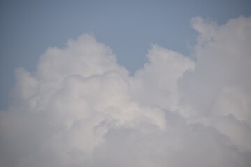 Blue sky with puffy white clouds.
