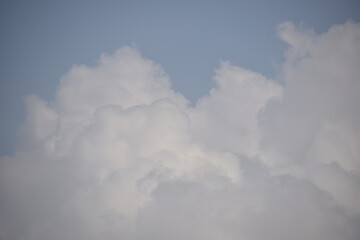 Blue sky with puffy white clouds.