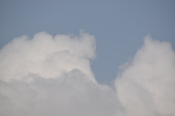 Blue sky with puffy white clouds.