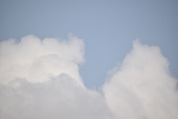 Blue sky with puffy white clouds.