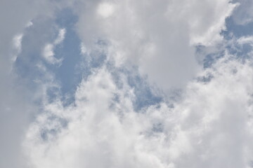 Blue sky with puffy white clouds.