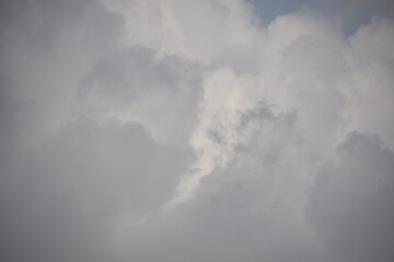 Blue sky with puffy white clouds.