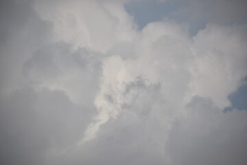Blue sky with puffy white clouds.