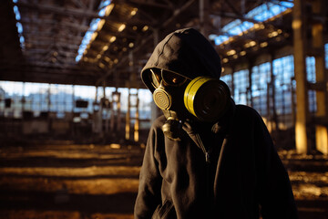 Person in gas mask in abandoned industrial building