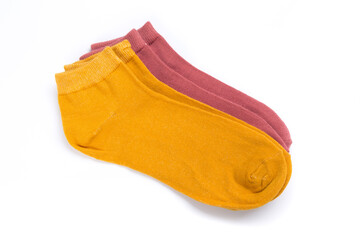 two pairs of colored short socks on a white background, top view
