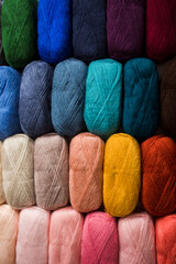 Various colors of wool yarn balls as a background